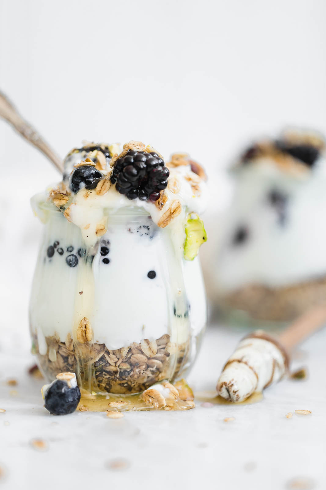 Cardamom Granola Parfait topped with honey