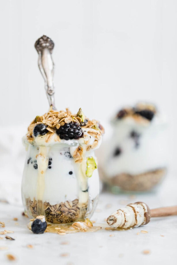 A chai-spiced Cardamom Granola Parfait made with the most addicting Cardamom Granola, and topped with blackberries and honey.