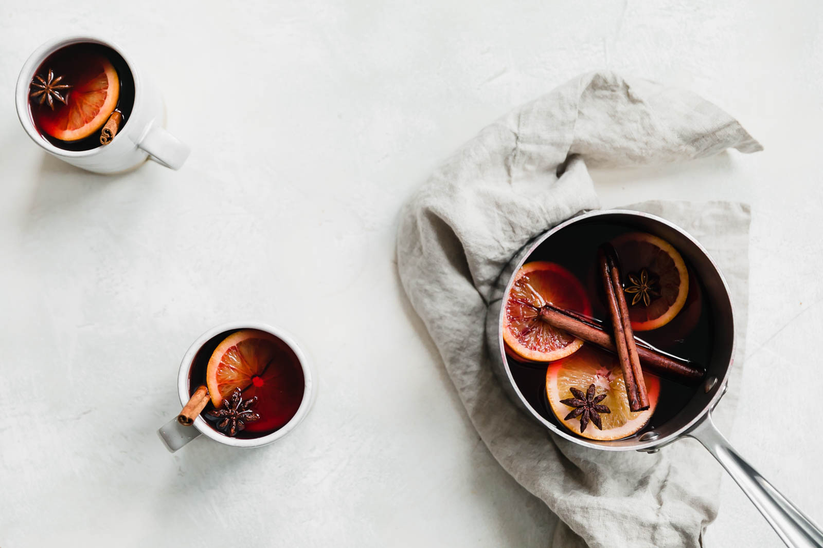 mulled wine in mugs and sauce pan