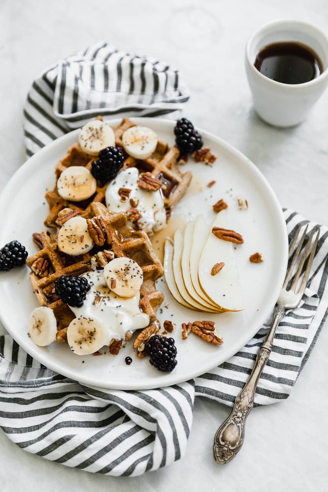 pumpkin spice waffles with fruit, nuts, and yogurt