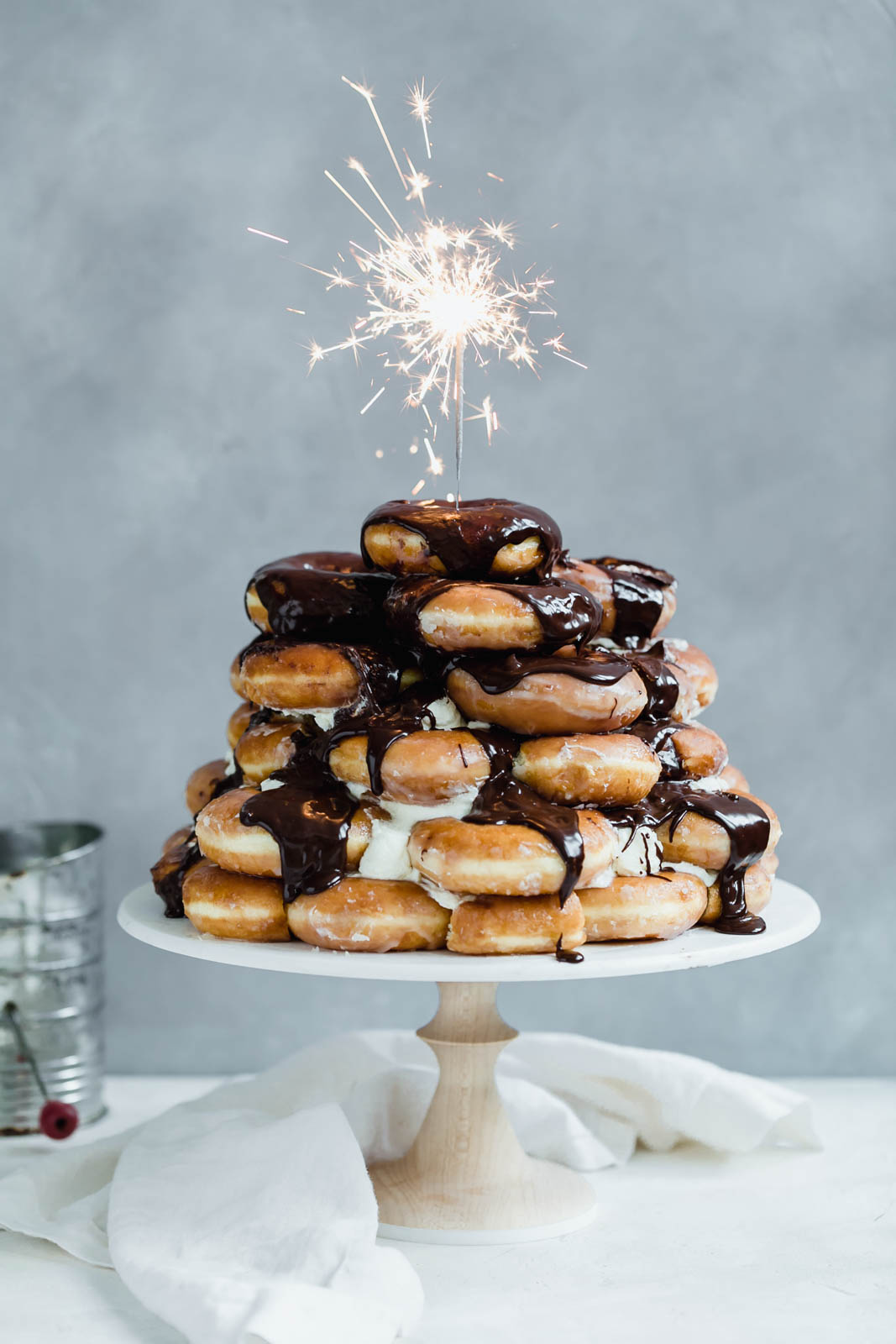 Towering Krispy Kreme donut cake smothered in chocolate frosting
