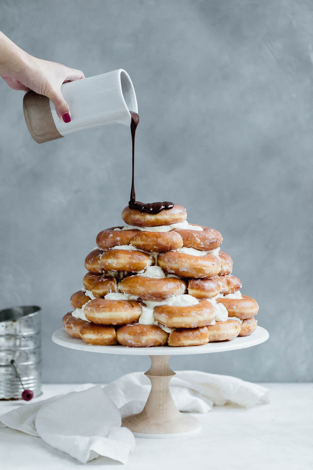 Towering Krispy Kreme donut cake smothered in chocolate frosting