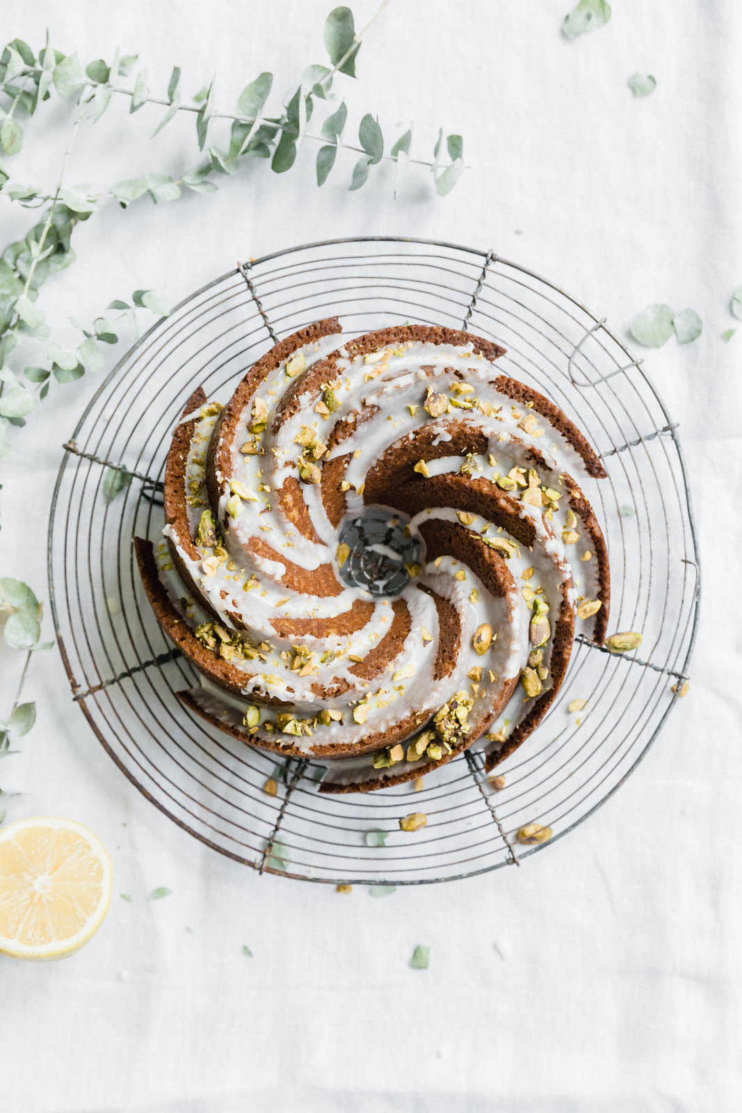 pistachio olive oil cake on a wire rack