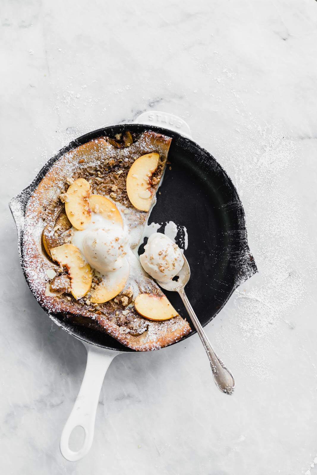 A deliciously epic bourbon brown butter peach dutch baby topped with granola, fresh peaches, and vanilla ice cream! Perfect for a lazy Sunday morning :)