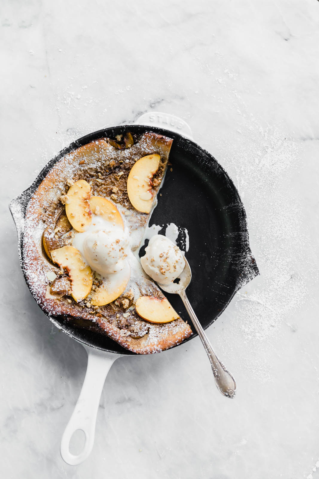 A deliciously epic bourbon brown butter peach dutch baby topped with granola, fresh peaches, and vanilla ice cream! Perfect for a lazy Sunday morning :)