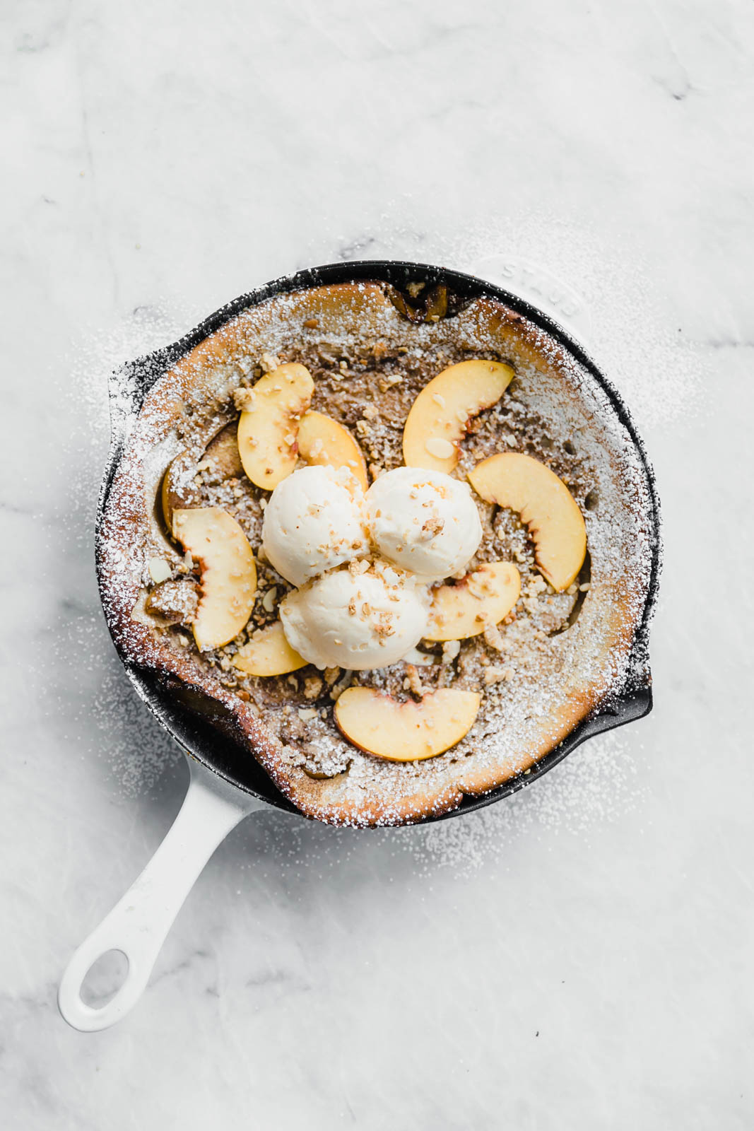 A deliciously epic bourbon brown butter peach dutch baby topped with granola, fresh peaches, and vanilla ice cream! Perfect for a lazy Sunday morning :)