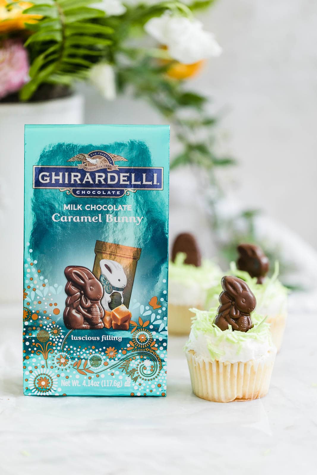 Easter Bunny Cupcake next to a bag of chocolate