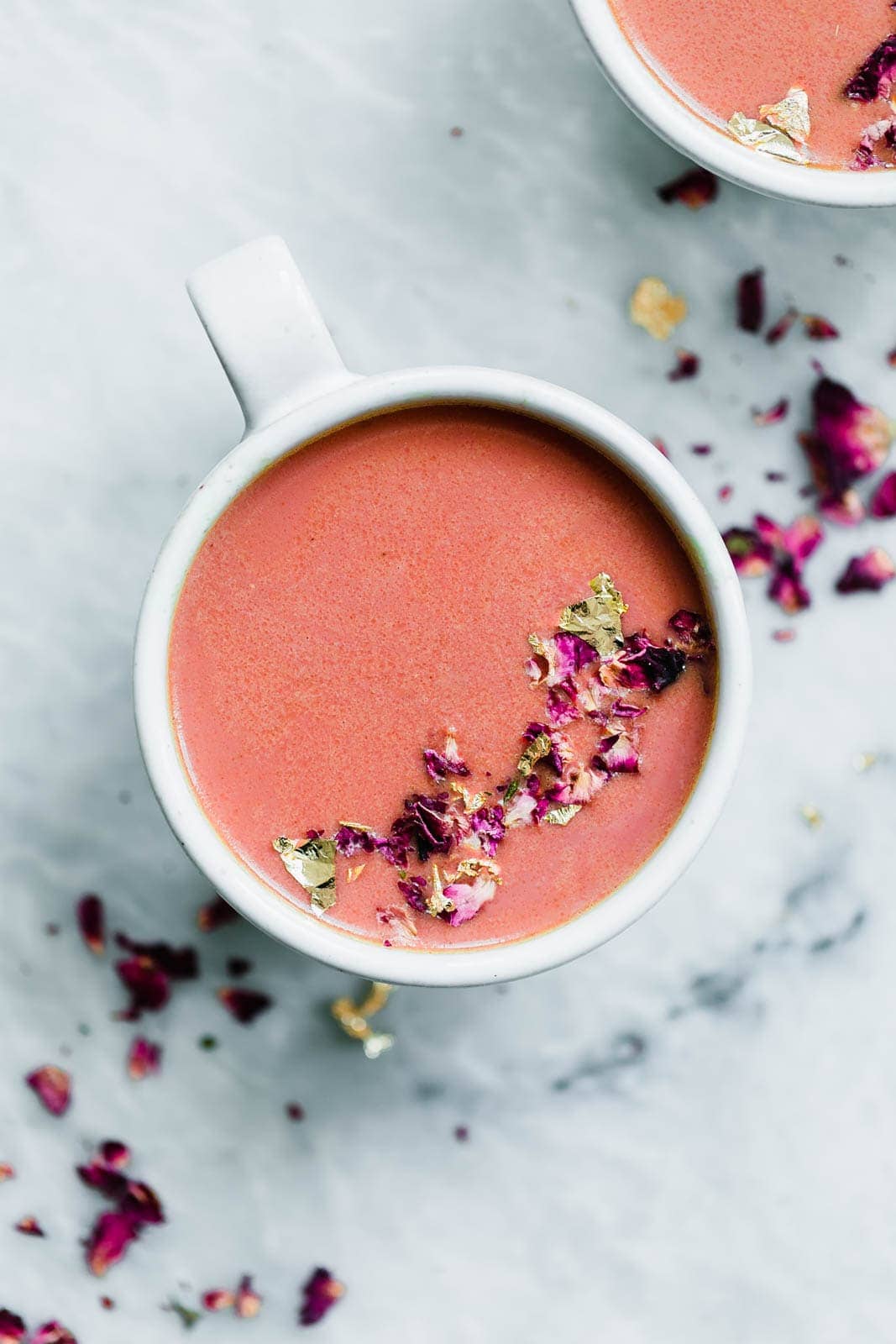 Elevate your bedtime routine with this Pink Moon Milk fit for a princess. Made with vanilla almondmilk, beetroot, turmeric, agave, dried rose hips, and edible gold.