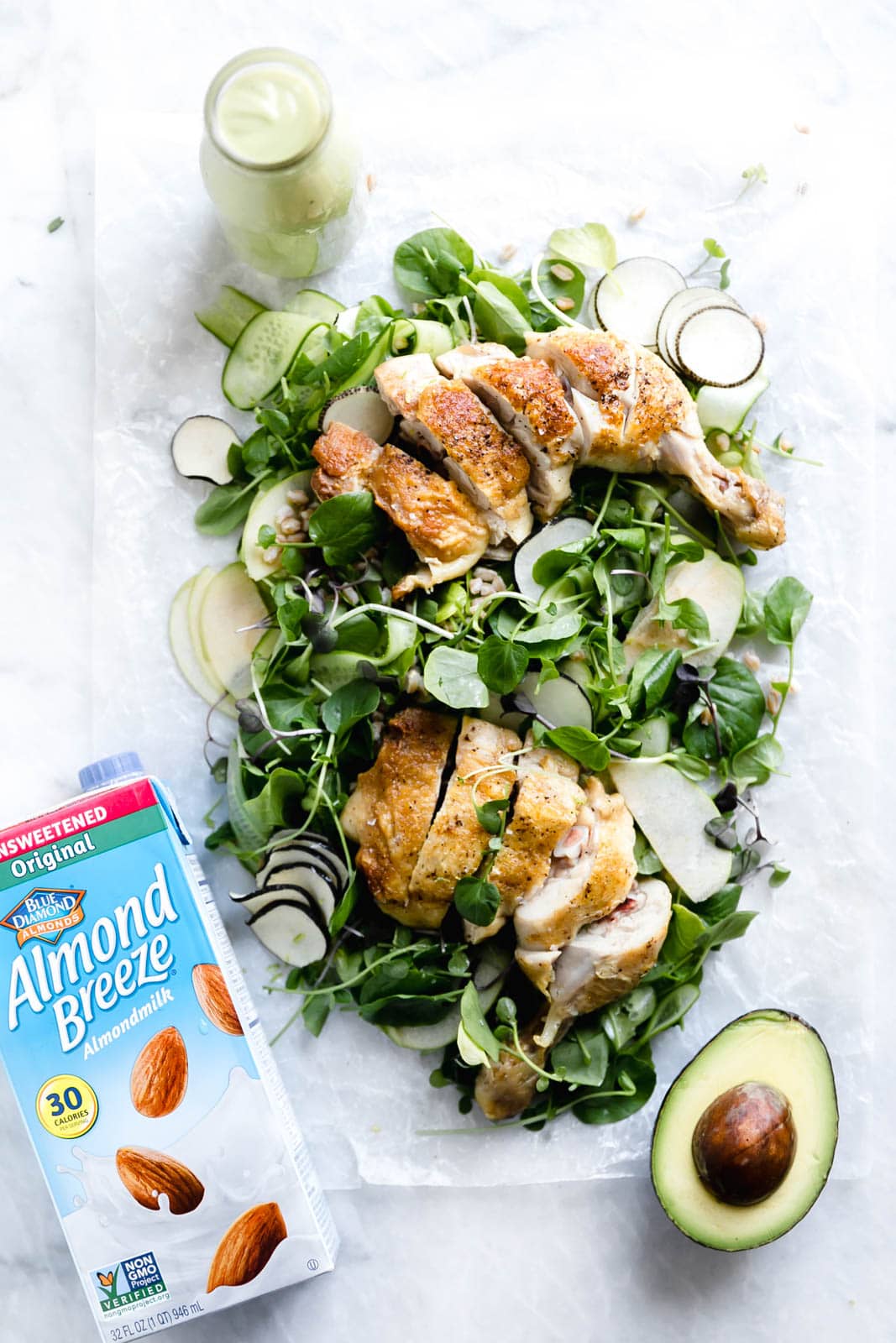 A loaded green chicken salad with watercress, green apples, farro, and a "creamy" dairy-free avocado dressing! So perfect for summer entertaining.