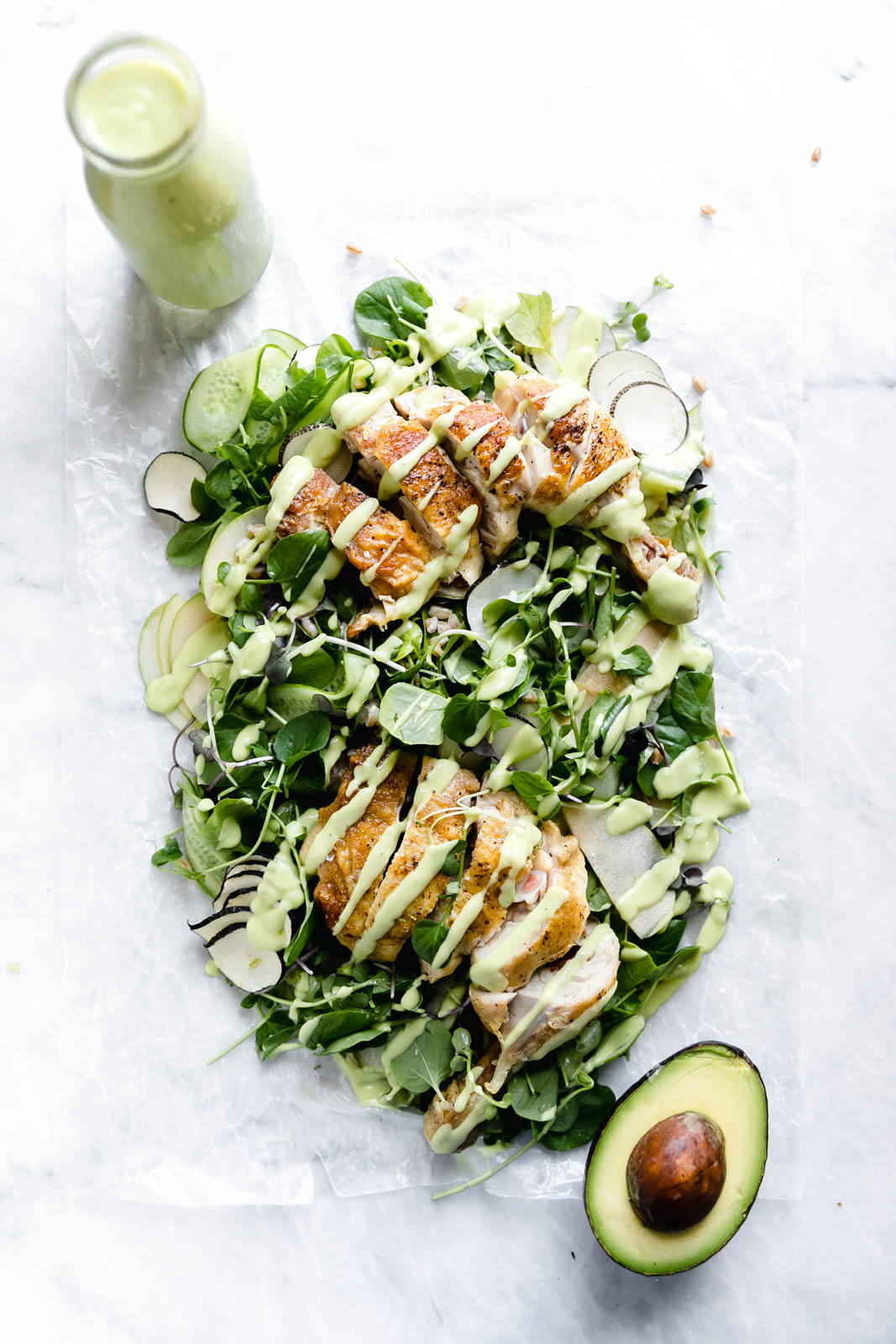 A loaded green chicken salad with watercress, green apples, farro, and a "creamy" dairy-free avocado dressing! So perfect for summer entertaining.