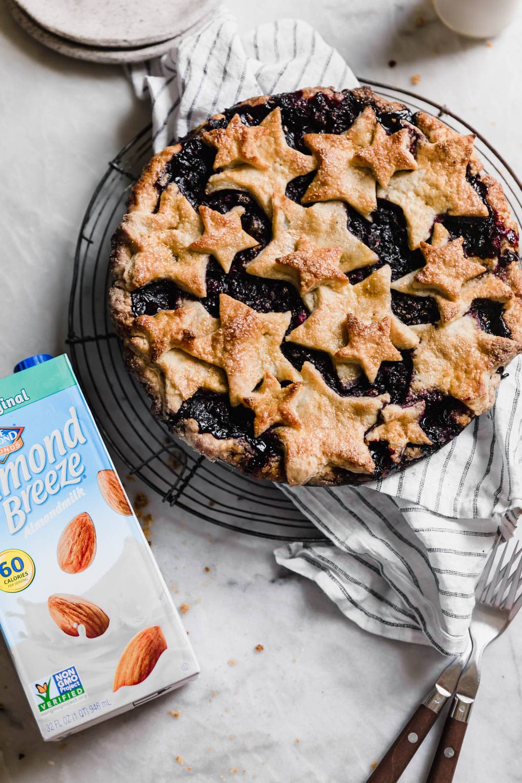 blueberry pie next to carton of almond milk