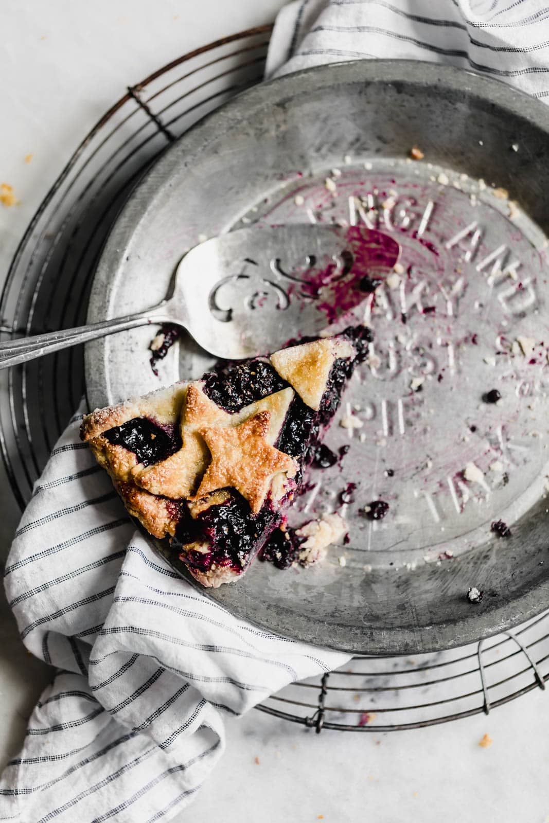 slice of blueberry pie in a pie pan