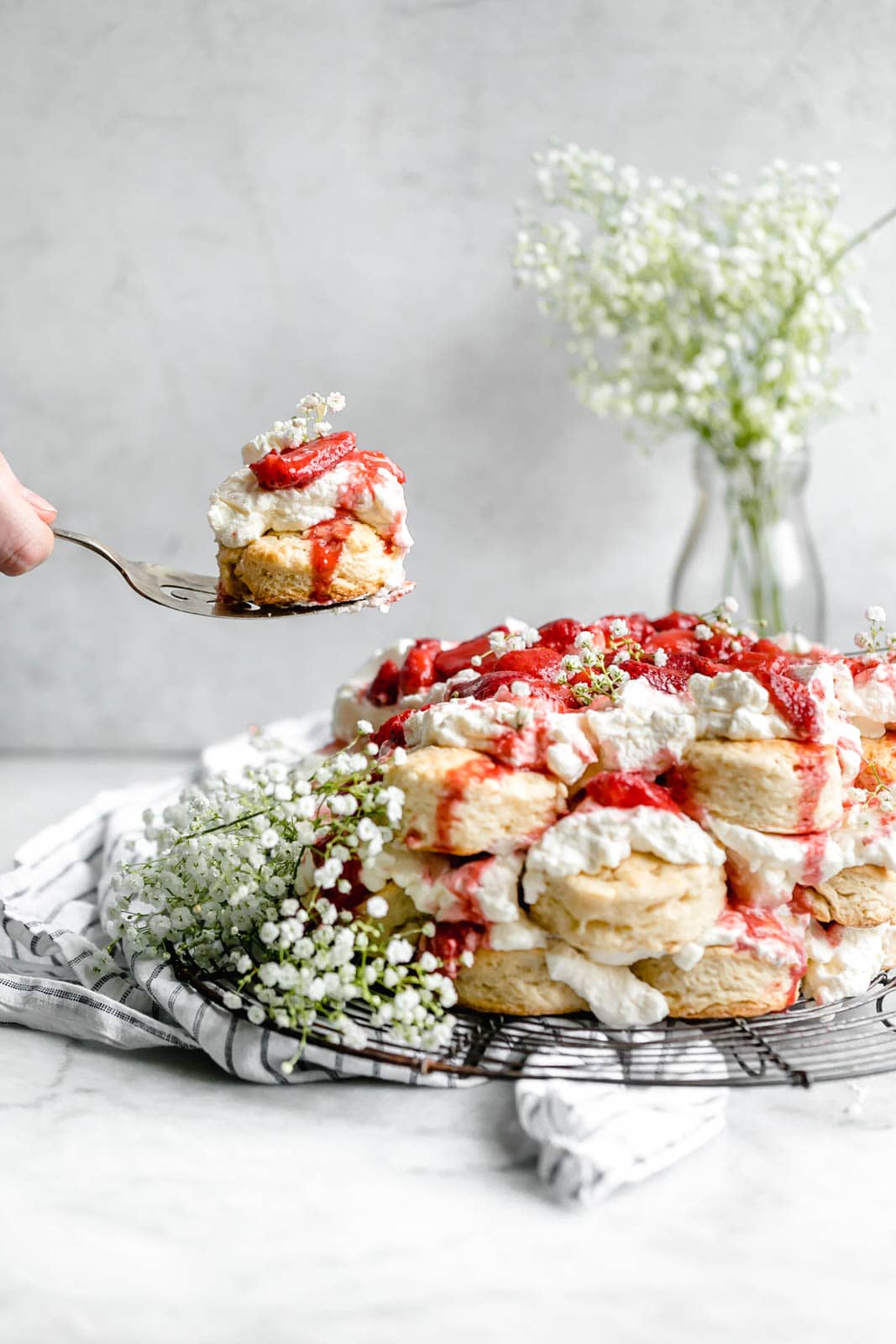 serving a slice of strawberry shortcake cake