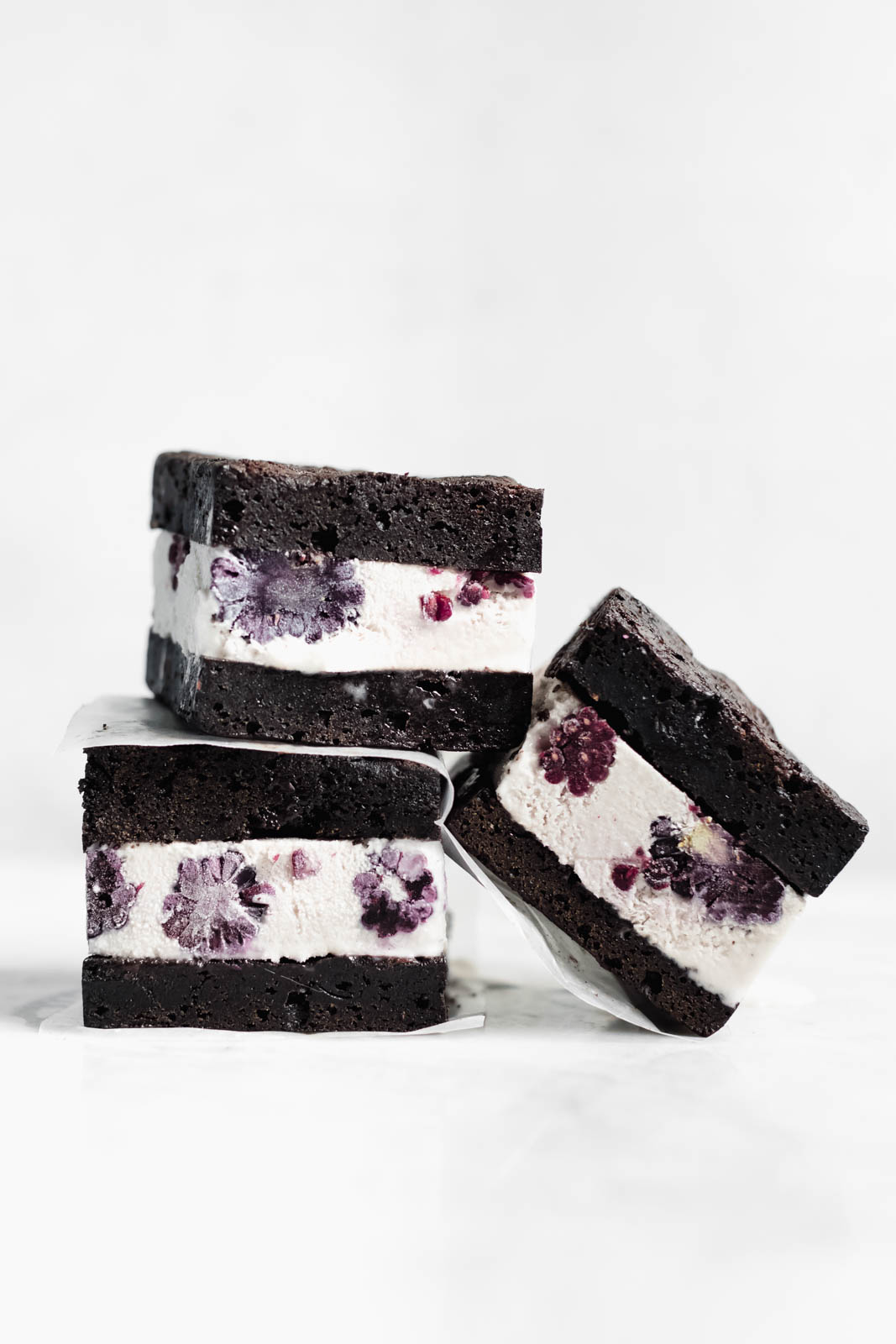 Brownie Ice Cream Sandwiches are the new thing. Made with boxed brownies and store-bought vanilla ice cream mixed with blackberry purée!
