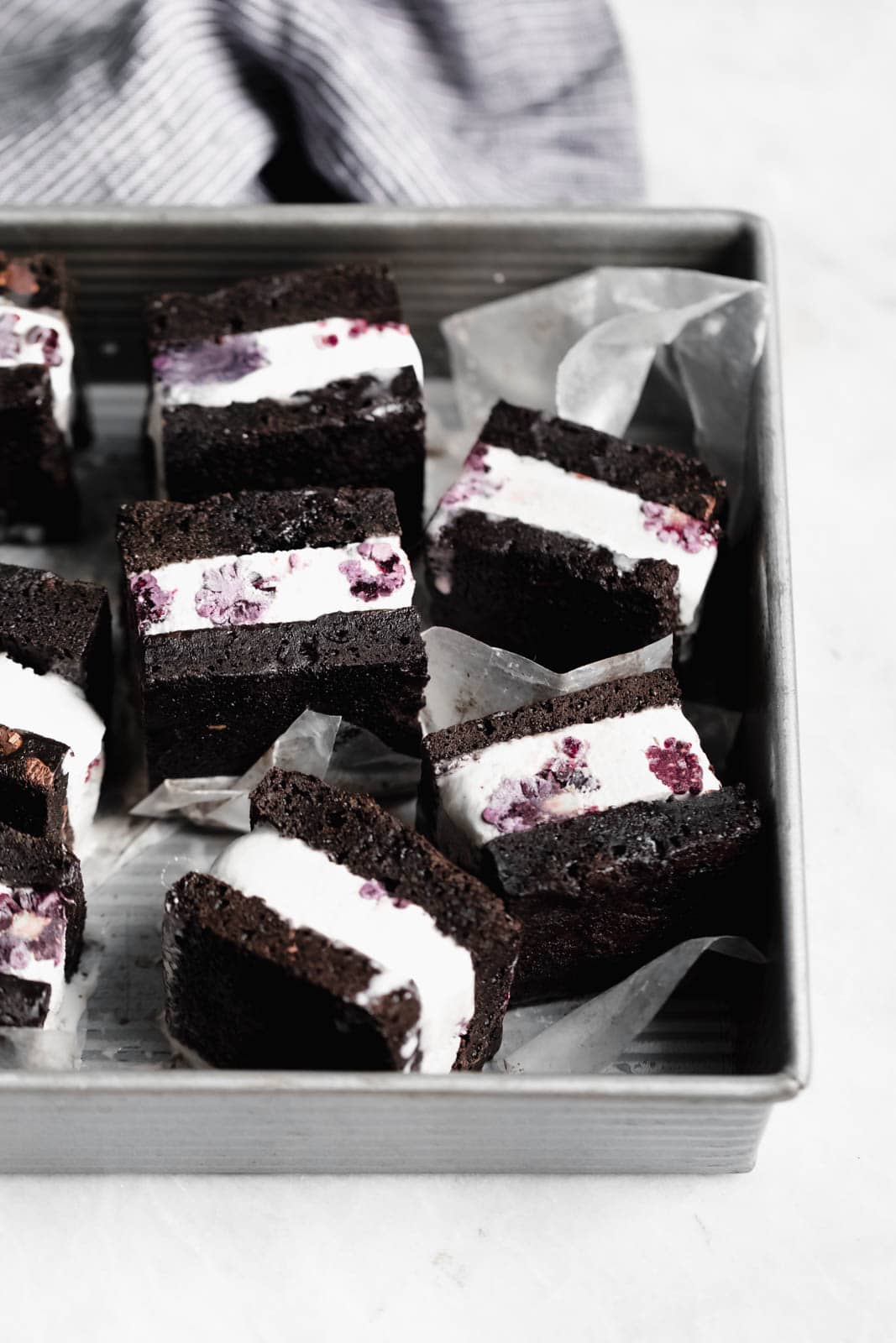 Brownie Ice Cream Sandwiches are the new thing. Made with boxed brownies and store-bought vanilla ice cream mixed with blackberry purée!