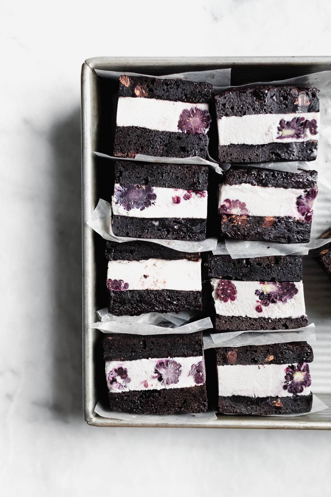 Brownie Ice Cream Sandwiches are the new thing. Made with boxed brownies and store-bought vanilla ice cream mixed with blackberry purée!