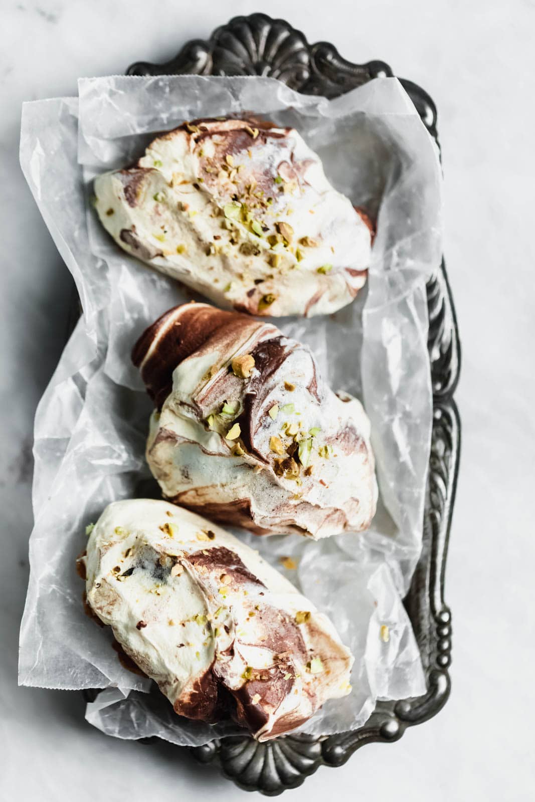 The easiest chocolate swirled spoon meringues that you literally spoon onto a baking sheet. Top 'em with crumbled pistachios, bake, and done!