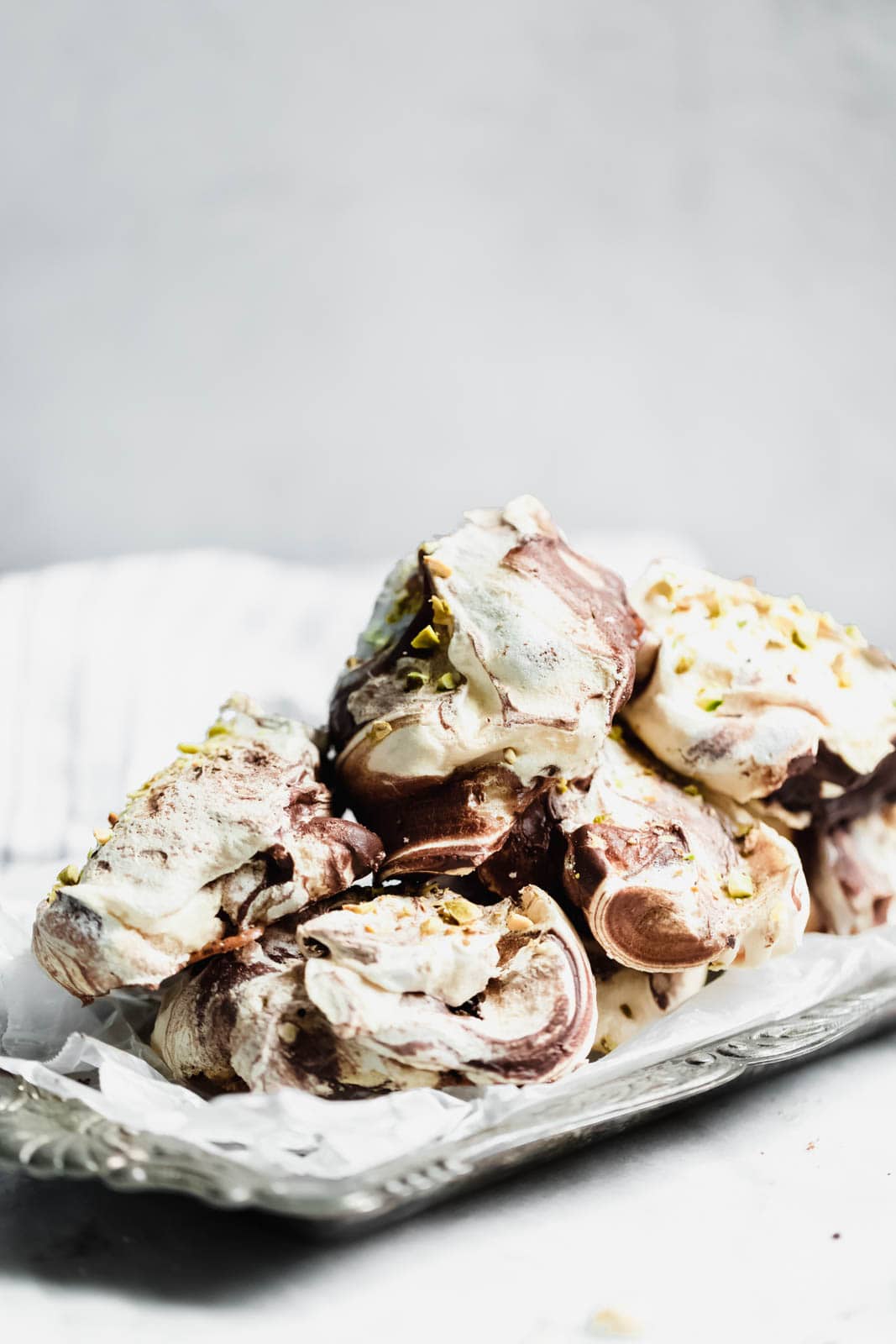 The easiest chocolate swirled spoon meringues that you literally spoon onto a baking sheet. Top 'em with crumbled pistachios, bake, and done!