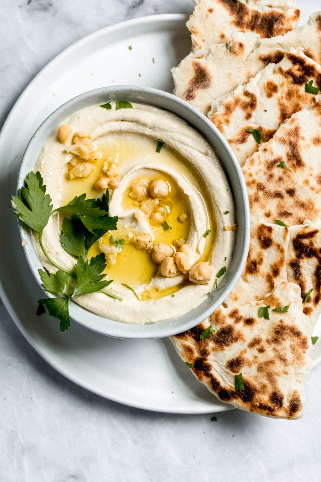 hummus in a bowl with naan and olive oil