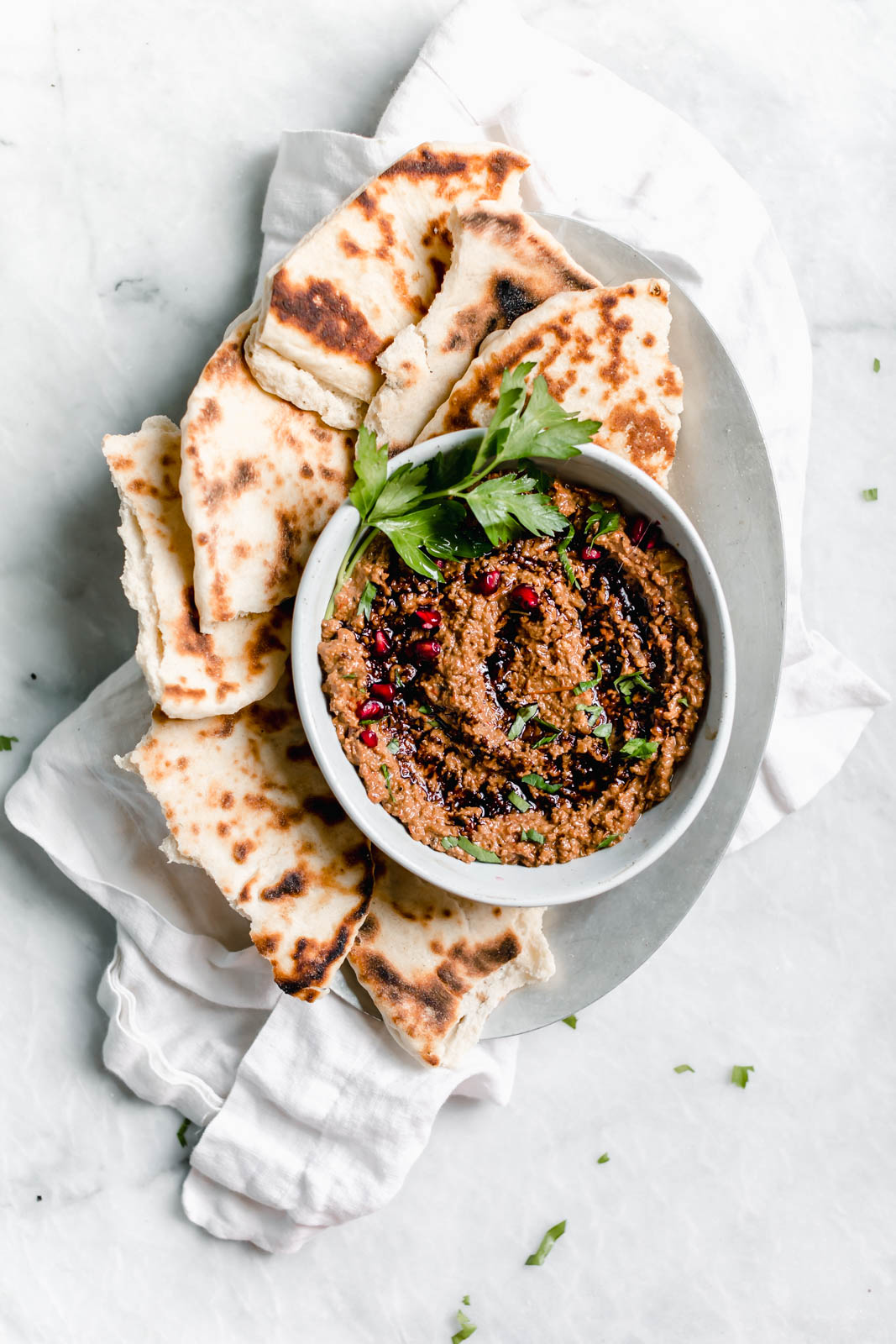 Muhammara dip on plate with pita bread
