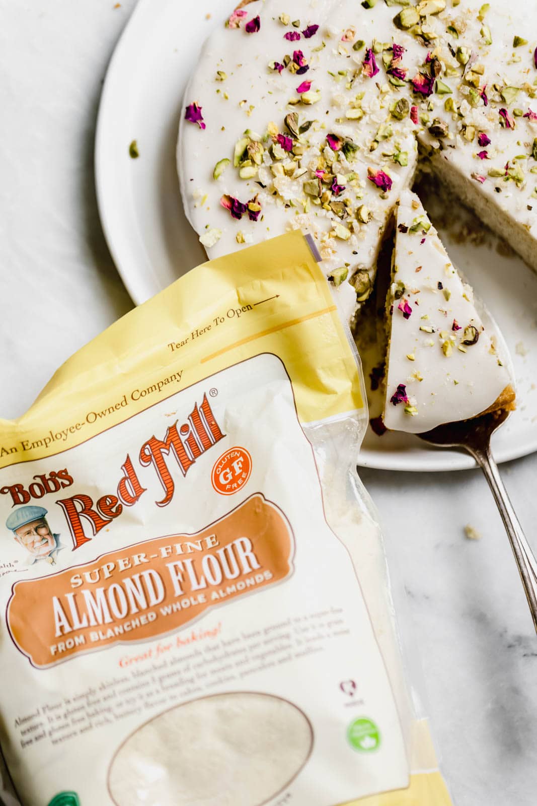 almond and rose cake next to a bag of almond flour