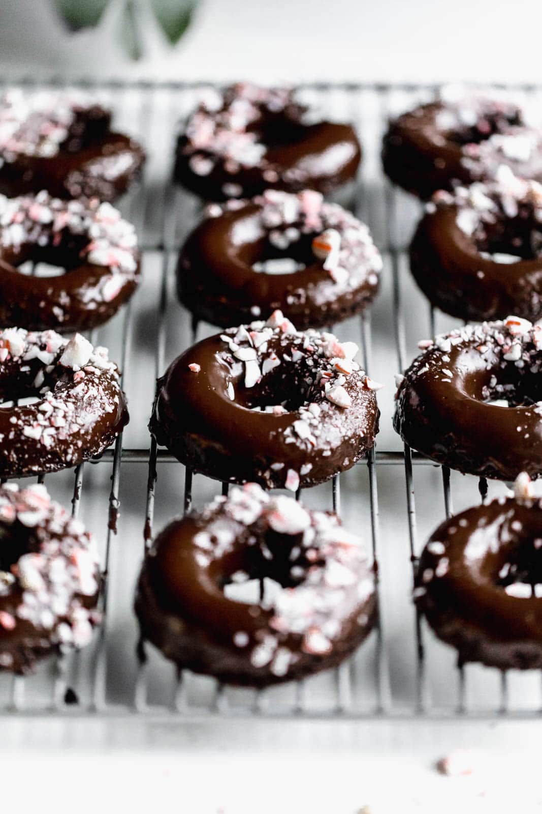 Ultra moist dairy-free and grain-free baked Peppermint Chocolate Donuts made topped with a dark chocolate ganache and candied peppermints. NOM.