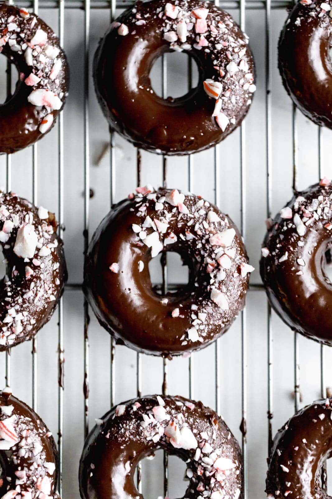 Ultra moist dairy-free and grain-free baked Peppermint Chocolate Donuts made topped with a dark chocolate ganache and candied peppermints. NOM.
