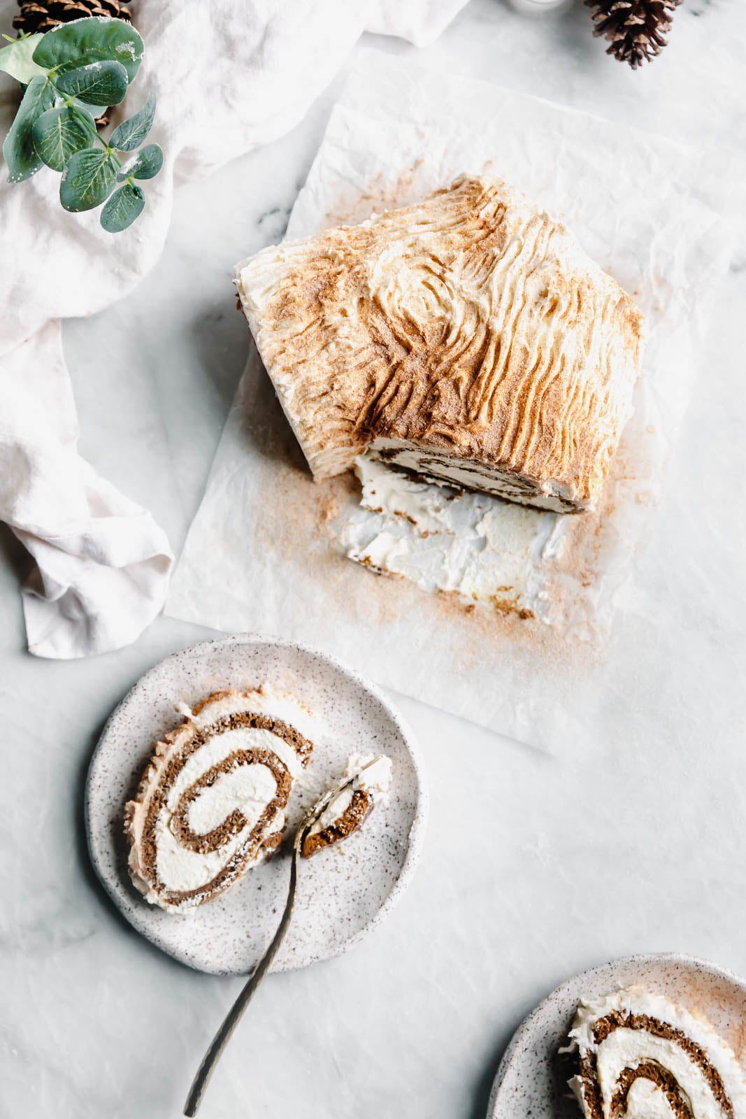 This festive White Chocolate Gingerbread Yule Log is a showstopper Christmas dessert. Made with white chocolate buttercream "bark" for that rustic look!