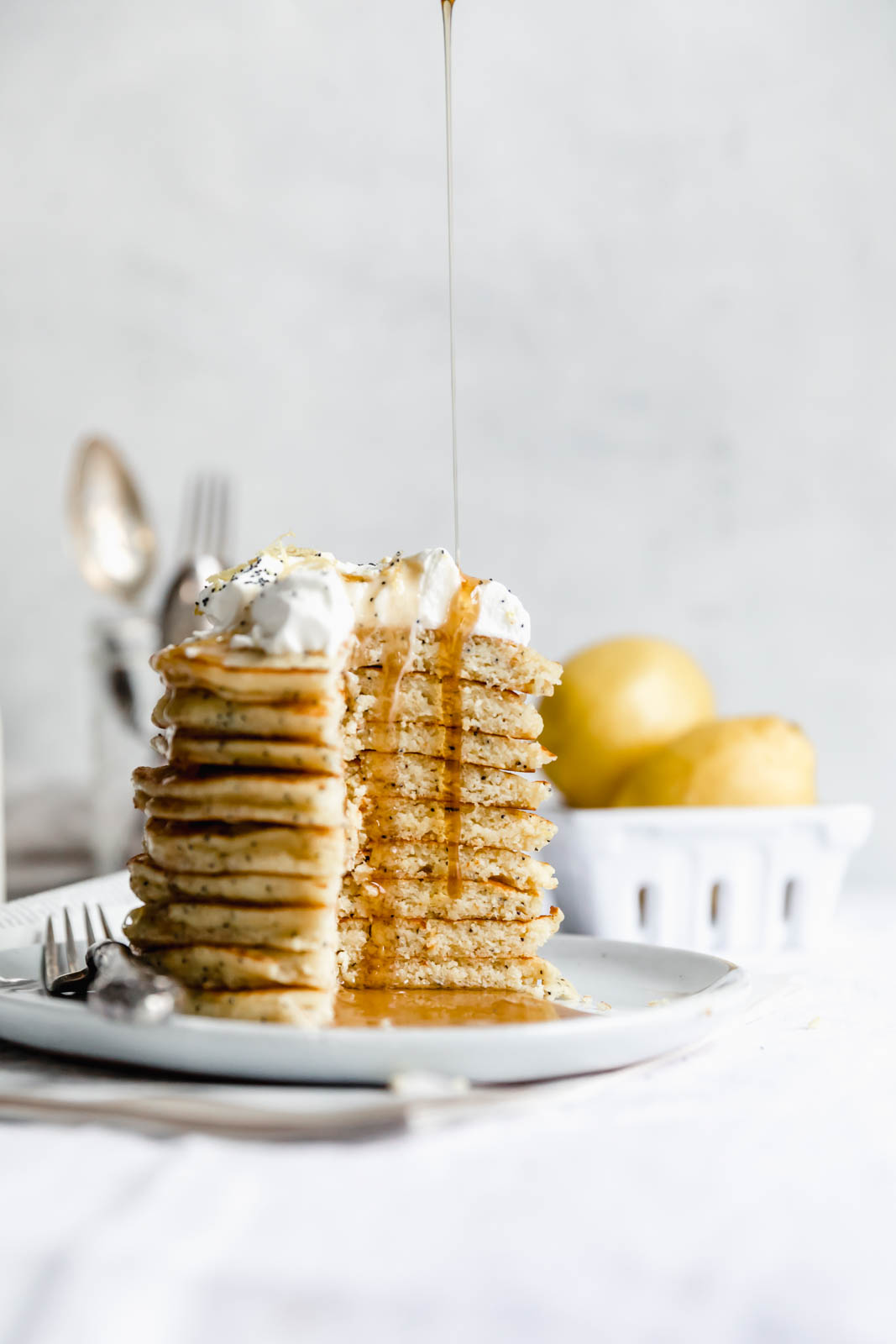 Light and fluffy Gluten Free Lemon Poppy Seed Pancakes made with almond flour and lemon zest. But proceed with caution: you might eat the whole batch!