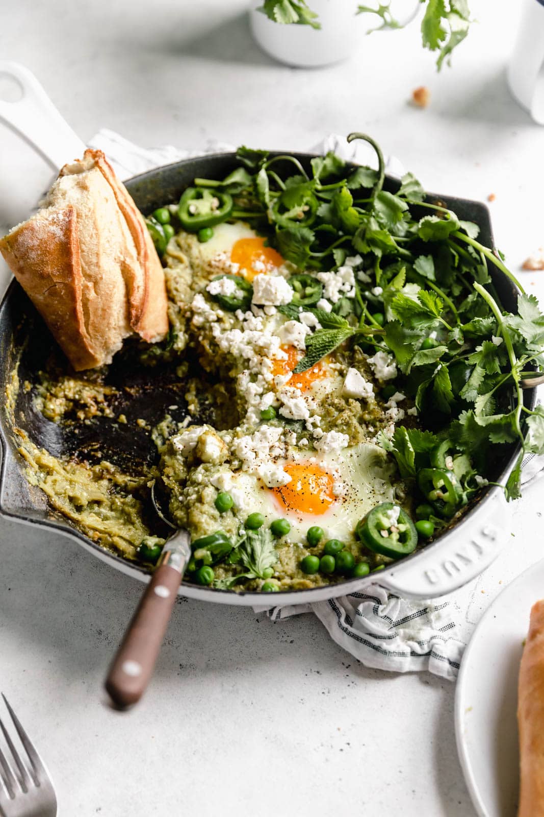 Green Shakshuka aka poached eggs cooked in a spiced green tomato sauce and topped with cilantro and feta. Talk about the best breakfast ever!