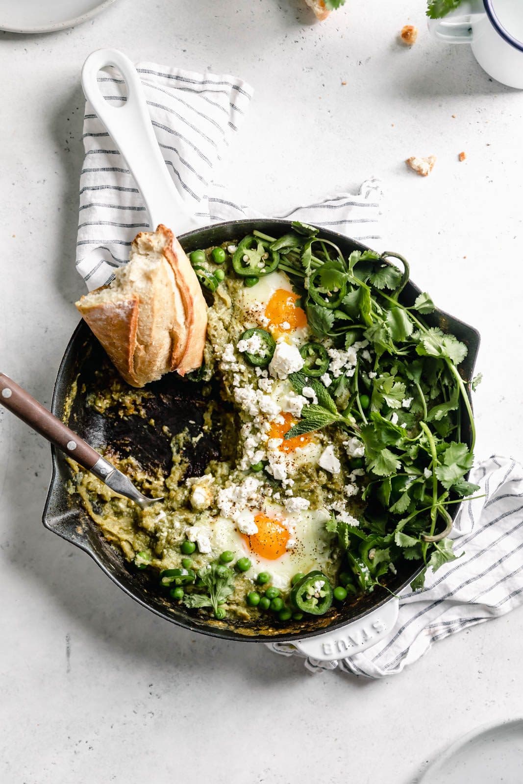 Green Shakshuka aka poached eggs cooked in a spiced green tomato sauce and topped with cilantro and feta. Talk about the best breakfast ever!