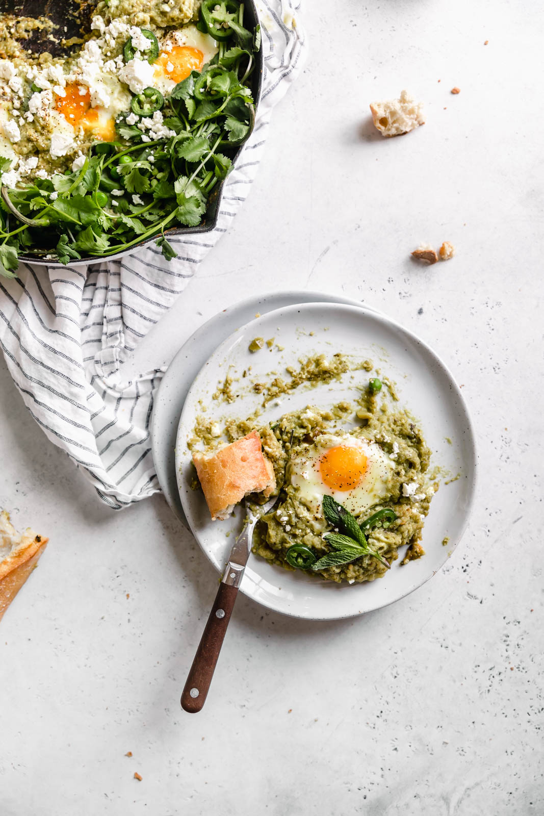 Green Shakshuka aka poached eggs cooked in a spiced green tomato sauce and topped with cilantro and feta. Talk about the best breakfast ever!