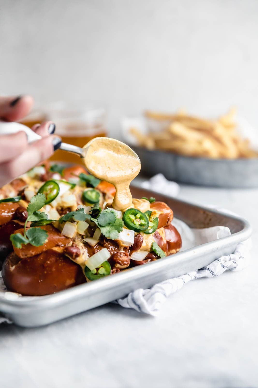 Vegan Chili Cheese Dogs with a creamy cashew queso so good even the most discerning meat-eaters will be impressed.