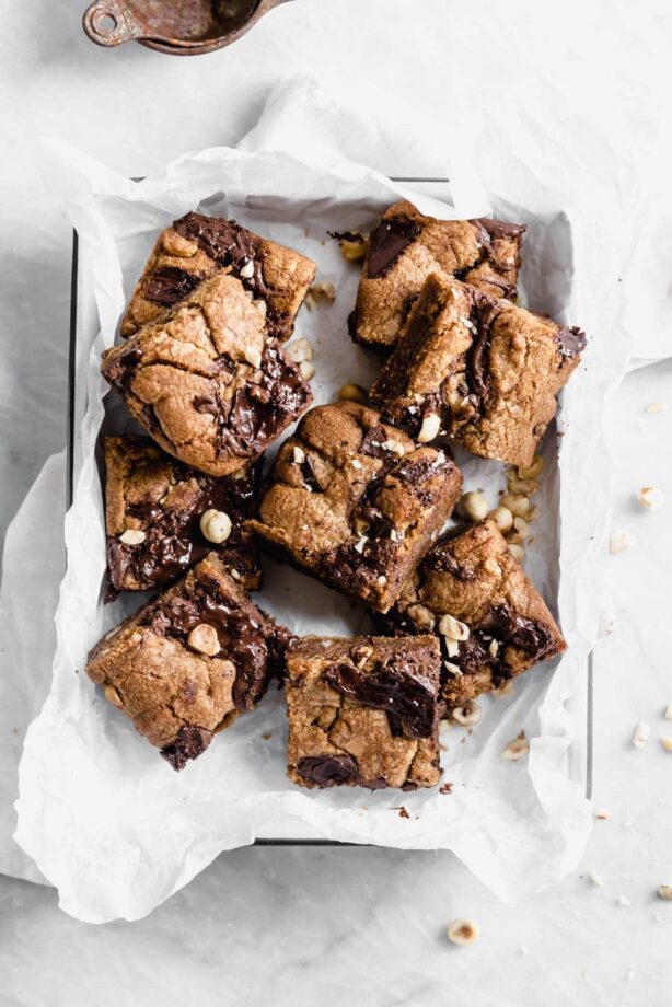 Brown Butter Nutella Chocolate Chip Cookie Bars with fat swirls of Nutella and lightly toasted hazelnuts. A salty sweet treat sure to be a showstopper.