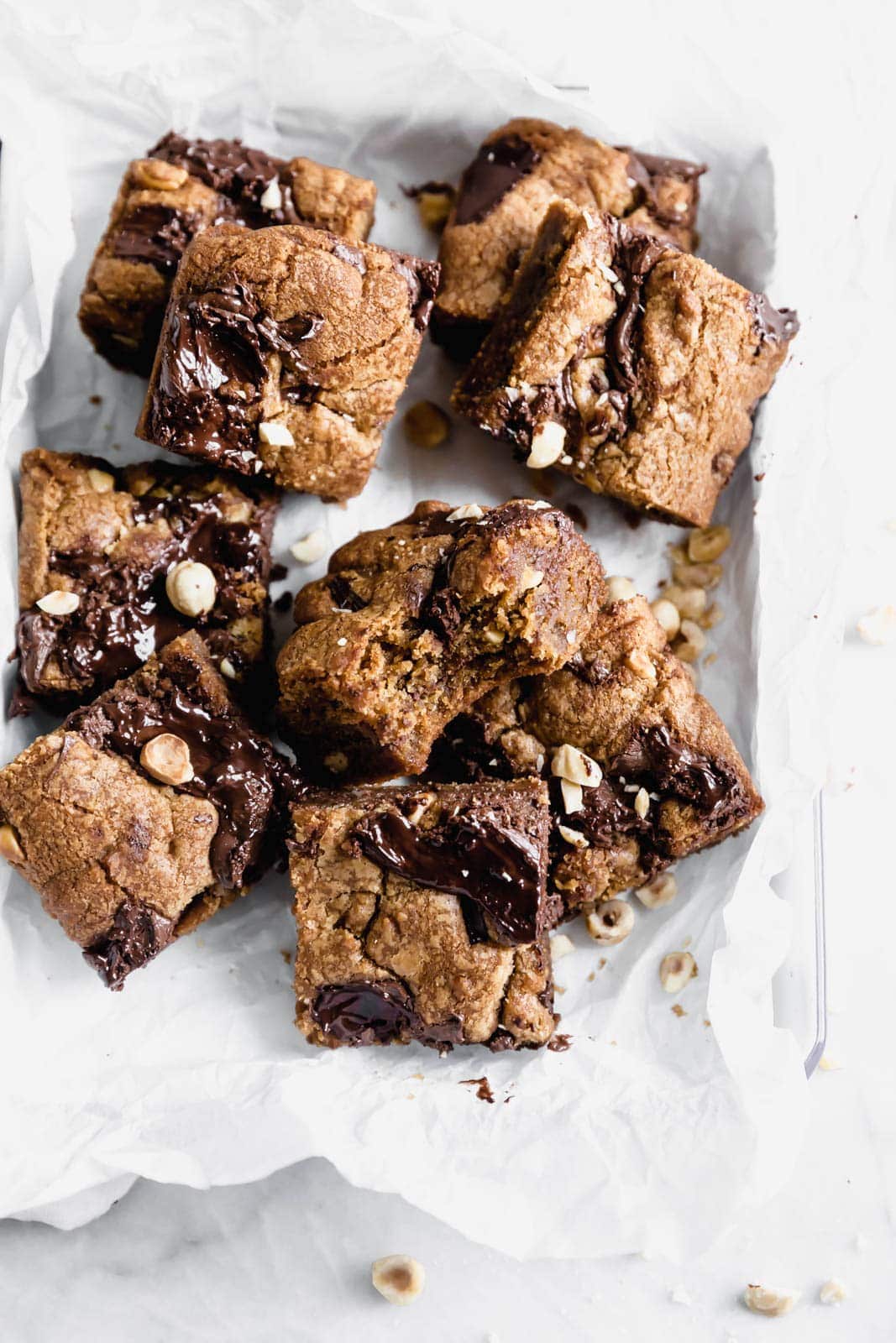 Brown Butter Nutella Chocolate Chip Cookie Bars with fat swirls of Nutella and lightly toasted hazelnuts. A salty sweet treat sure to be a showstopper.