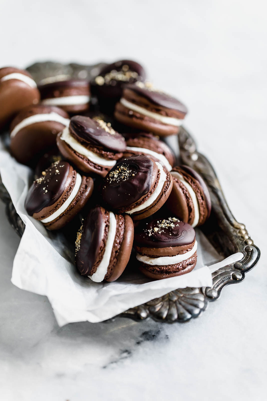 S'mores macarons with chewy chocolate macarons filled with an irresistibly fluffy marshmallow filling. All the classic campfire flavor, without the fire.