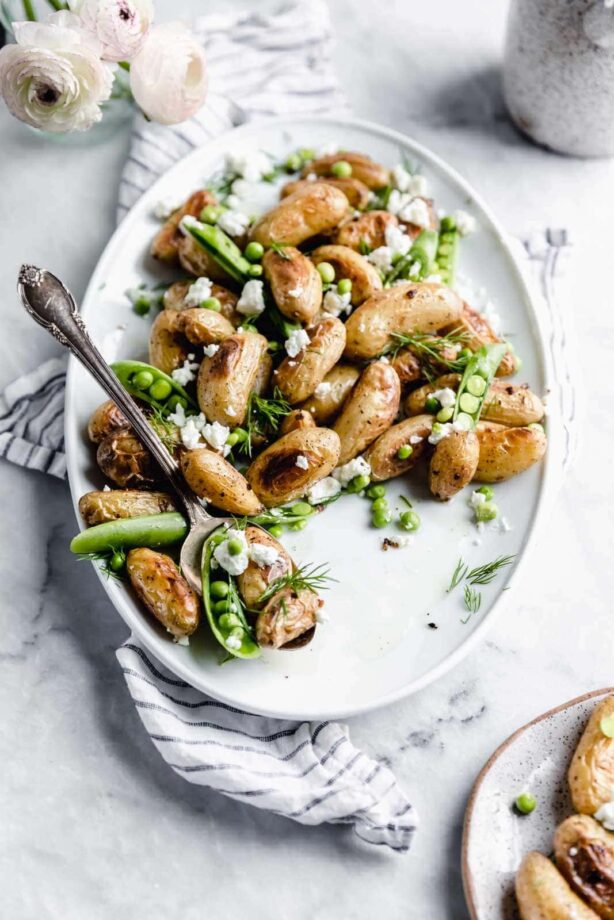 These roasted fingerling potatoes with dill, goat cheese, and peas are our new fav side dish. Full of texture and flavor, you'll love these spring potatoes.