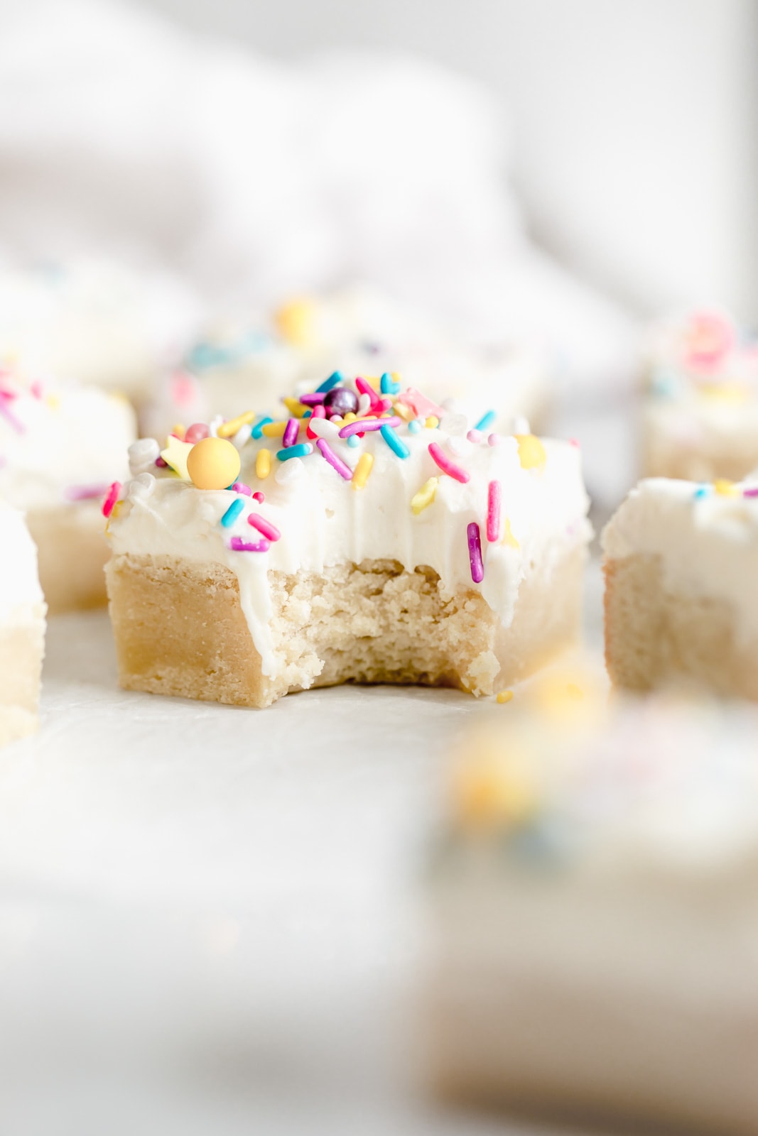 Buttery, chewy sugar cookie bars topped wtih a dreamy cream cheese frosting are the perfect easy dessert. Top this sweet treat with fun sprinkles and enjoy!