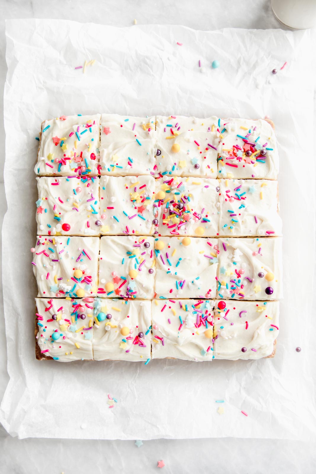 sugar cookie bars cut into squares with sprinkles on top