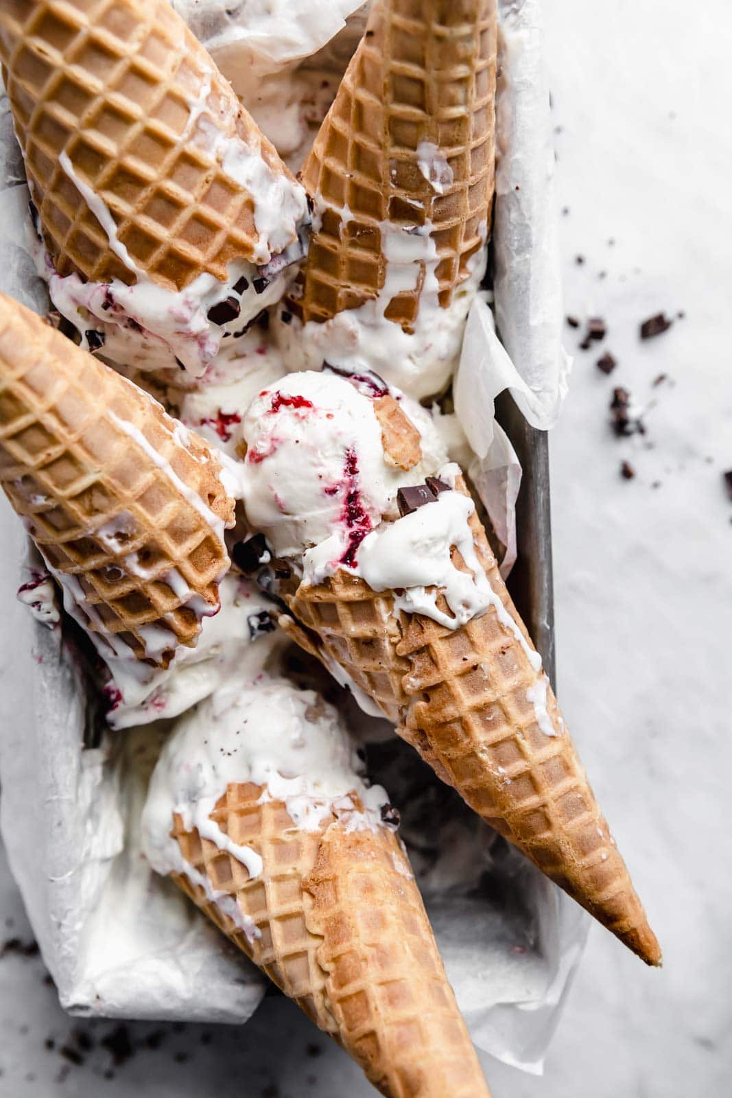 This creamy vanilla ice cream with fat blackberry swirls, buttery waffle pieces, and chocolate chips has us in heaven. Whip up this no churn blackberry waffle chocolate chip ice cream in minutes and skip the line at the ice cream shop.