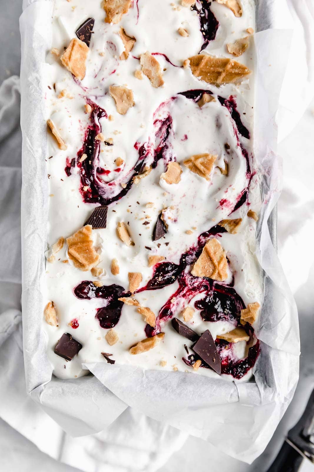 This creamy vanilla ice cream with fat blackberry swirls, buttery waffle pieces, and chocolate chips has us in heaven. Whip up this no churn blackberry waffle chocolate chip ice cream in minutes and skip the line at the ice cream shop.