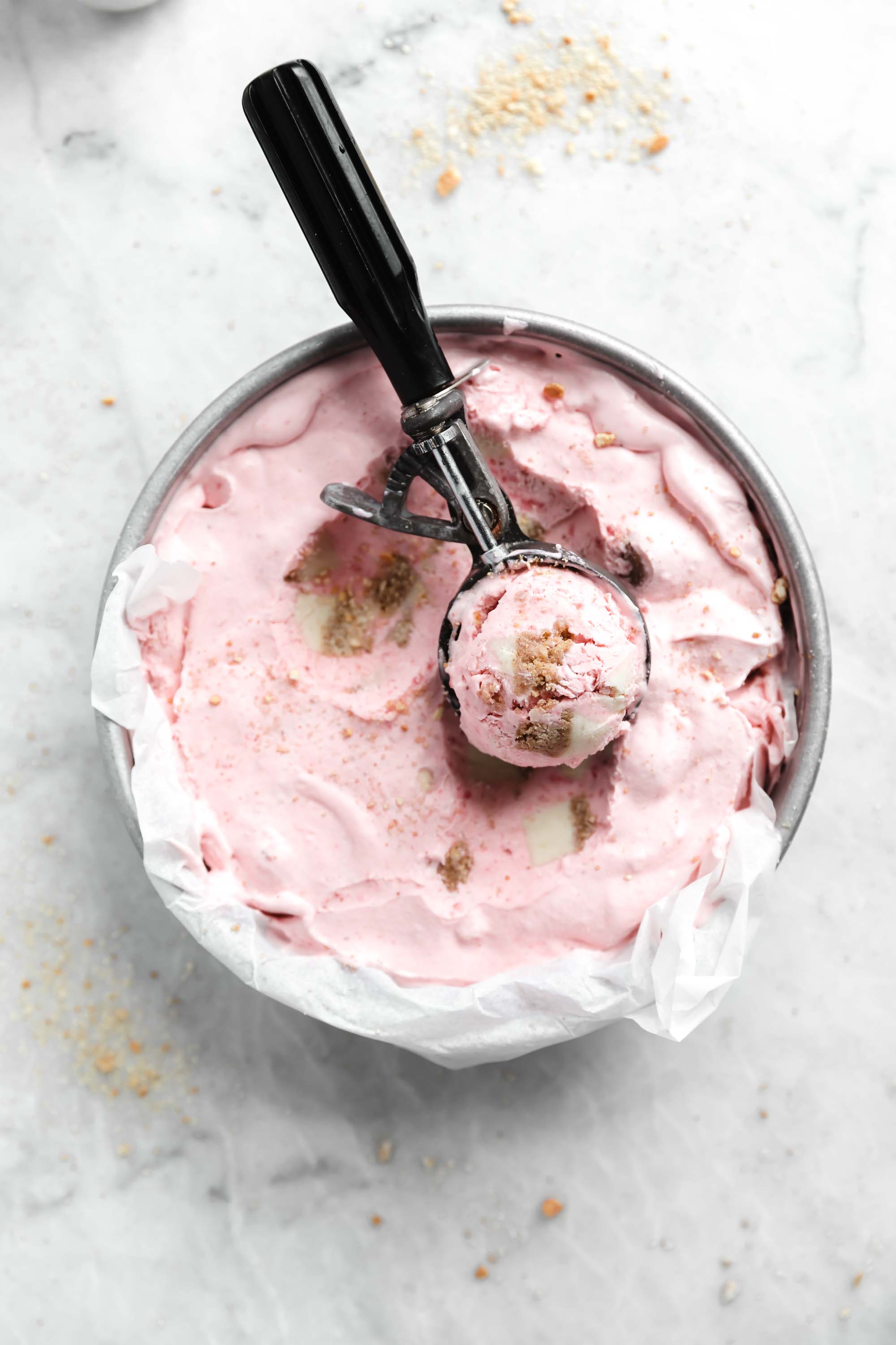 Kick off ice cream season with this easy and delicious no churn strawberry cheesecake ice cream. Creamy strawberry ice cream mixed with chunks of cheesecake. YUM.