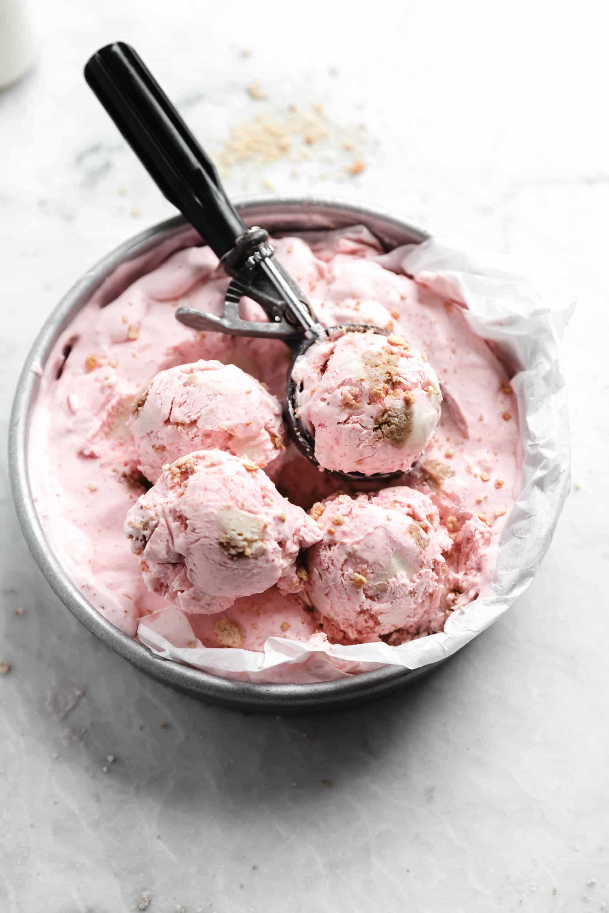 Kick off ice cream season with this easy and delicious no churn strawberry cheesecake ice cream. Creamy strawberry ice cream mixed with chunks of cheesecake. YUM.