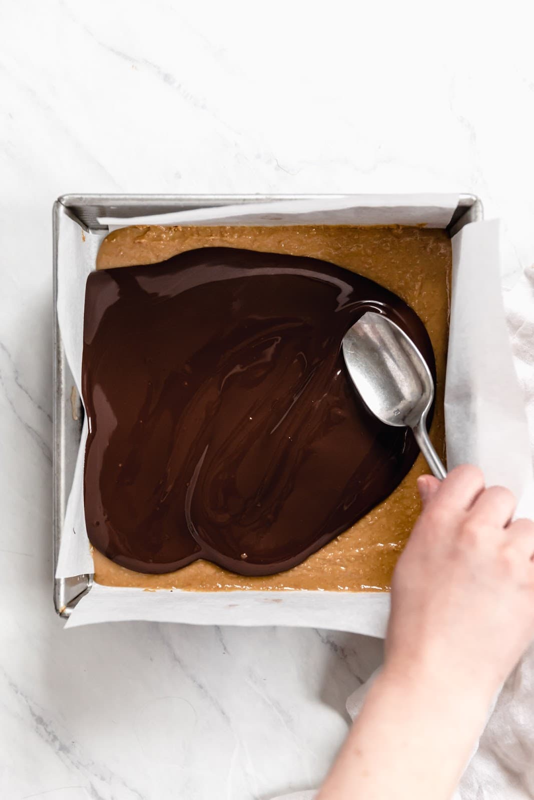 melted chocolate spread on peanut butter squares