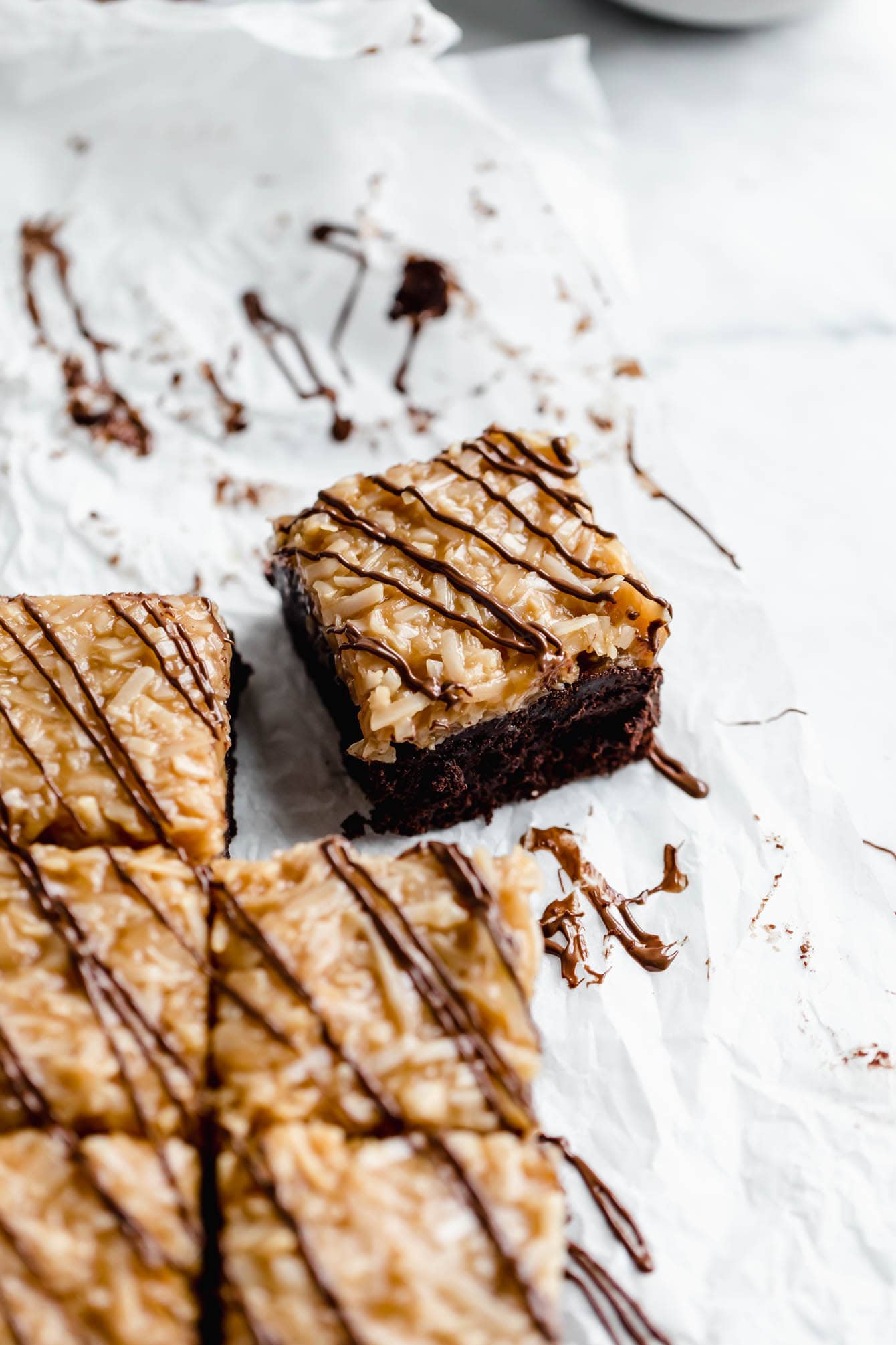 These Samoa brownies are fudgy brownies topped with homemade coconut caramel sauce and drizzled with chocolate. Perfect for any Girl Scout cookie lover!