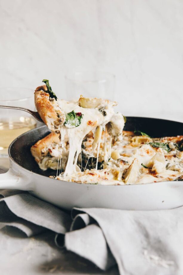 Easy cheesy spinach artichoke pizza so delicious, you'll eat the whole pie yourself