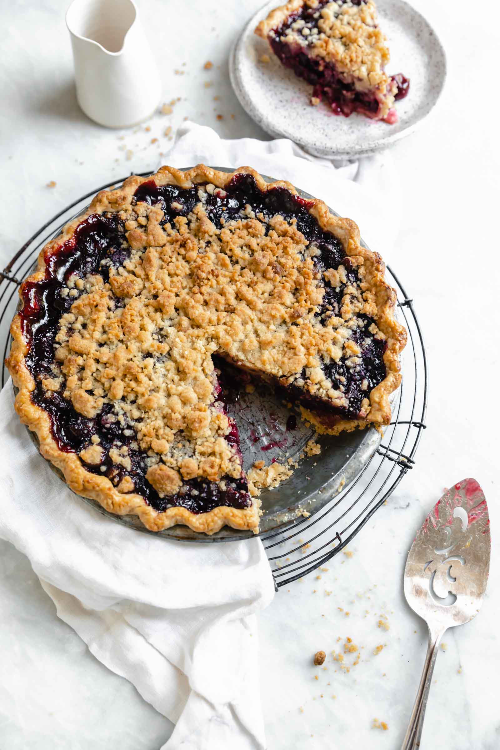 Introducing our favorite summer pie: Cherry Crumb Pie. A flaky pie crust filled with fresh cherries, and topped with crumble. The perfect cherry pie recipe!