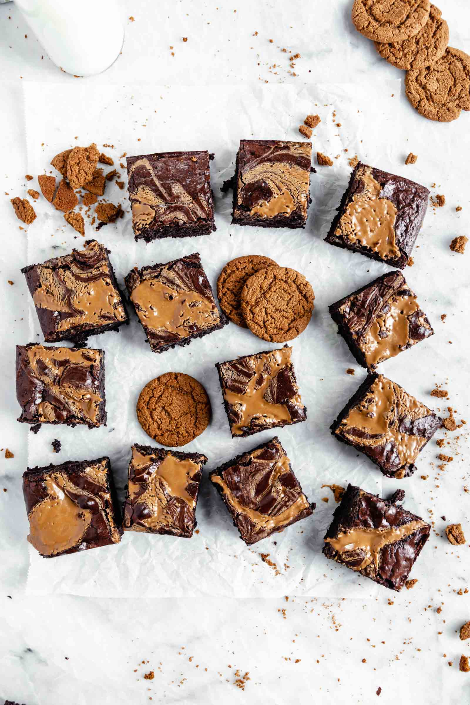 cookie butter swirled brownies with crushed up cookies on marble board