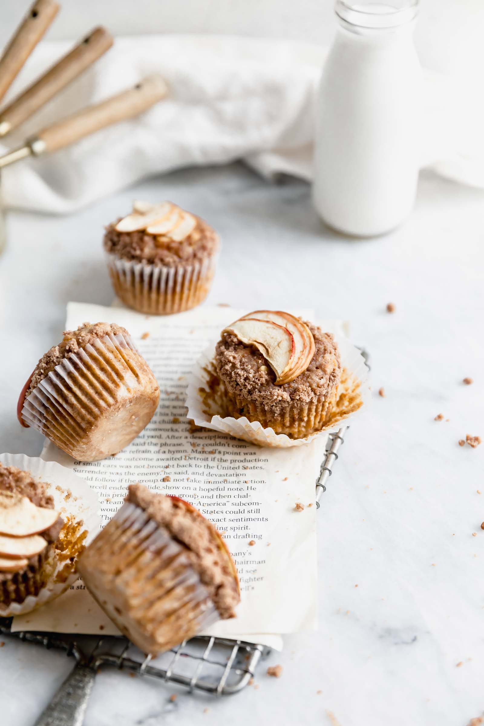 apple carrot muffins scattered over marble counter