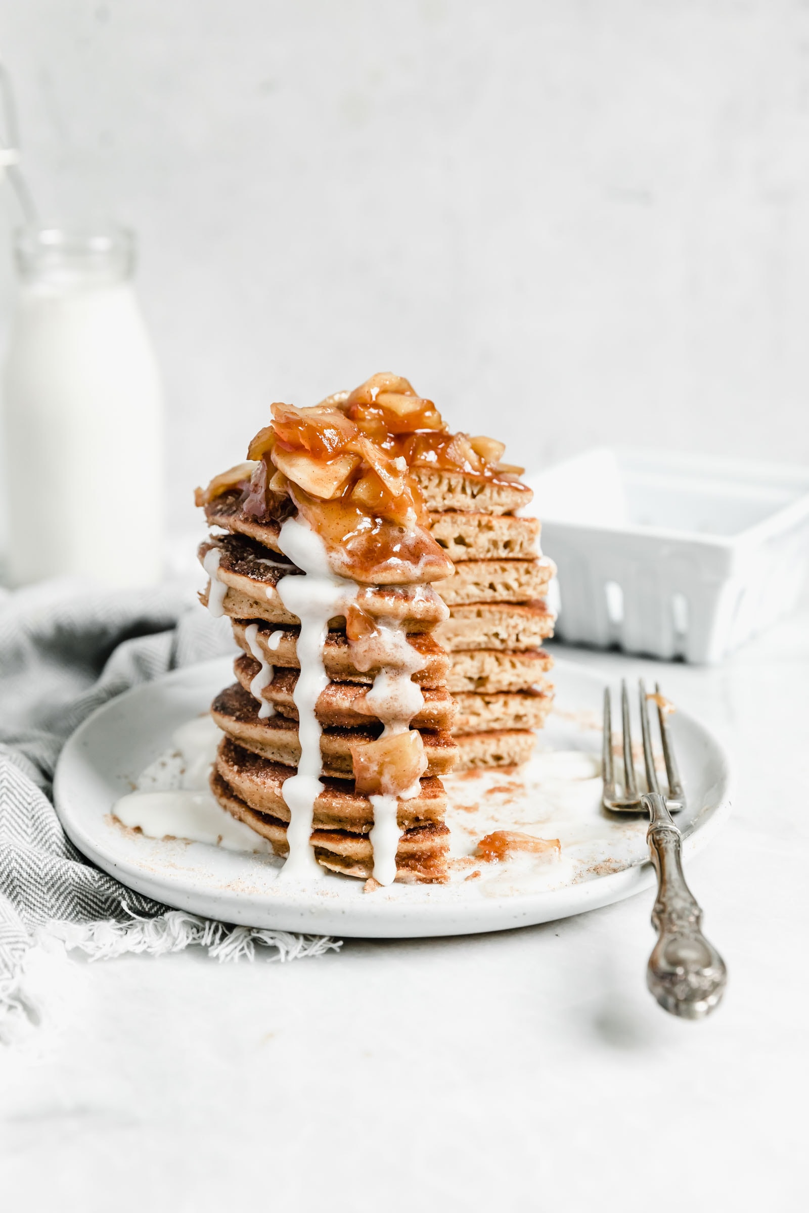stack of apple cider donut pancakes with quarter taken out